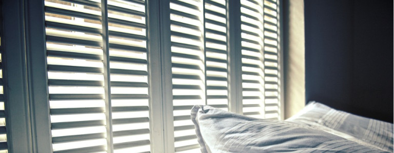 white-linen-against-white-shutters-with-white-light-behind-picture-id136933670